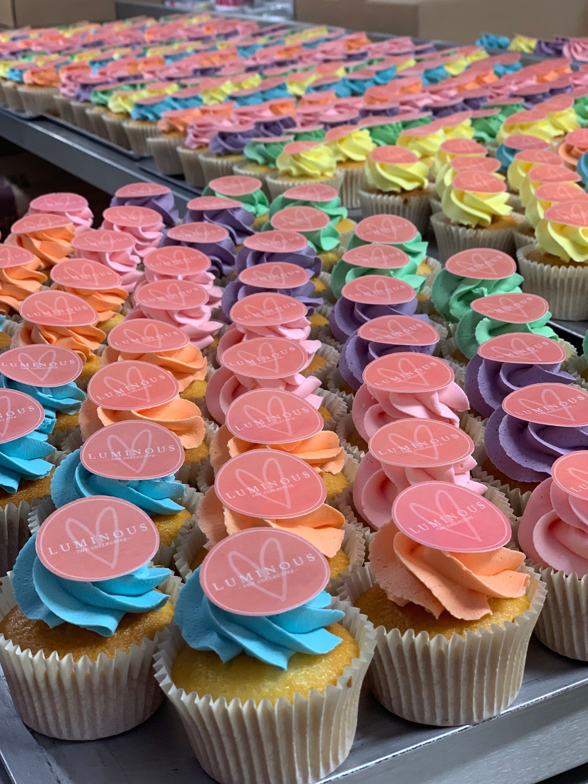 Freshly baked cupcakes with soft piped cream frosting