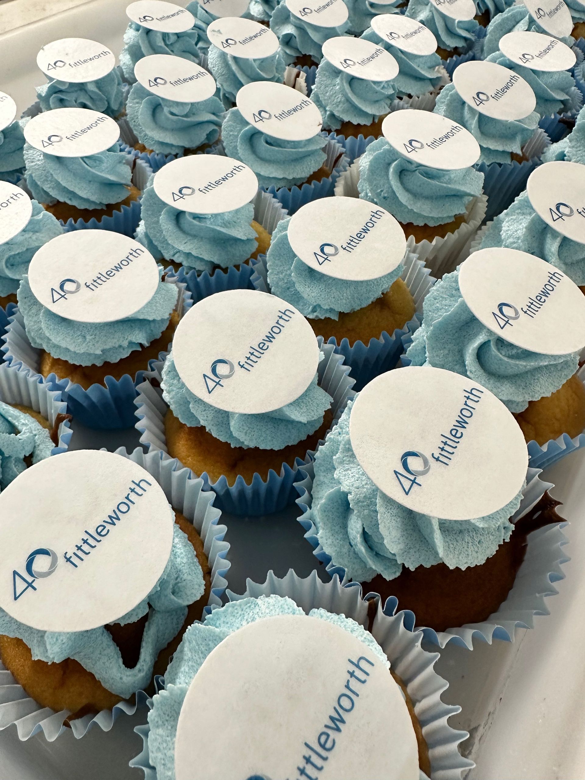 Fresh vanilla cupcakes with buttercream swirl