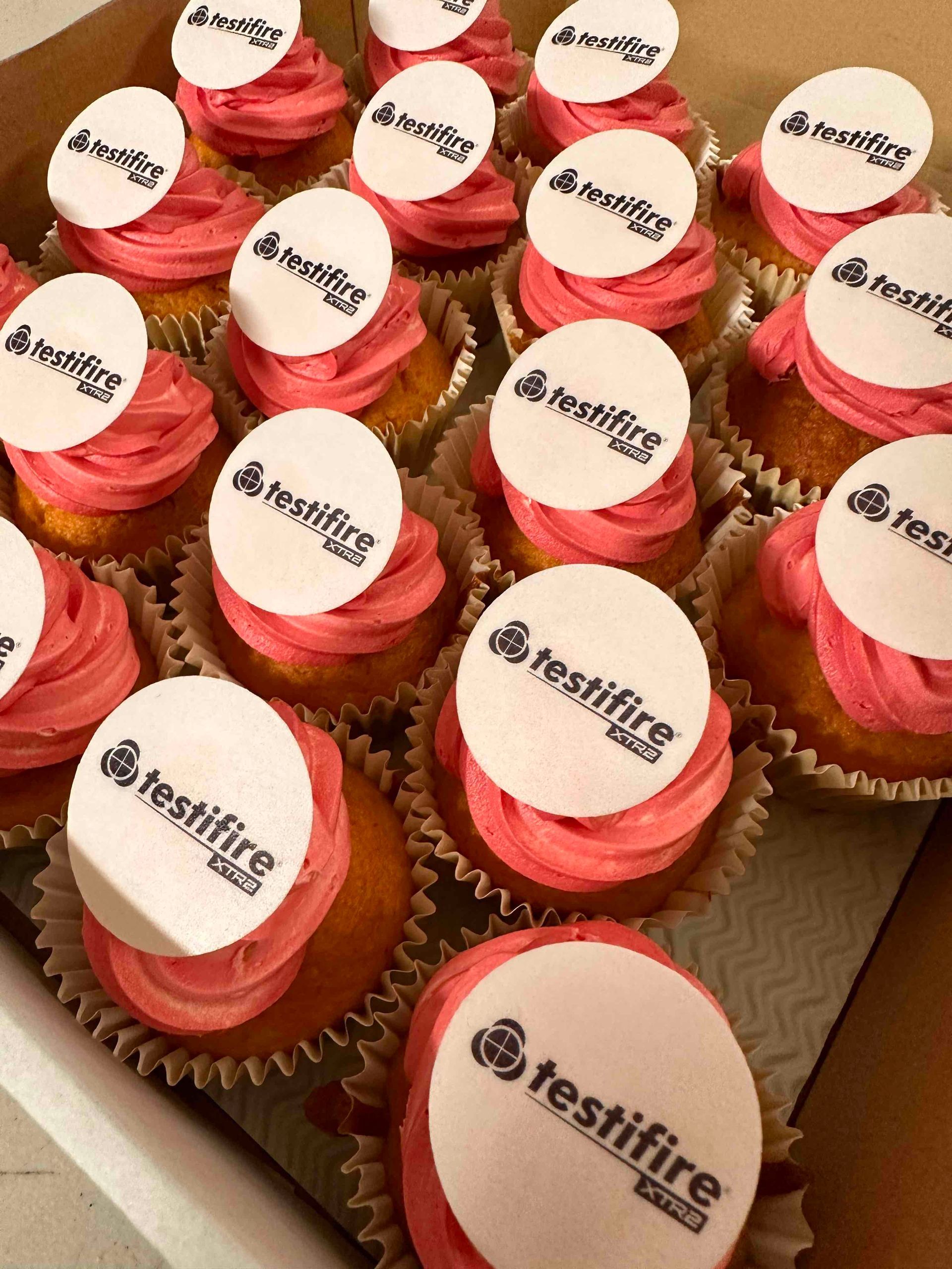 Testfire branded cupcakes with red logo toppers for corporate event
